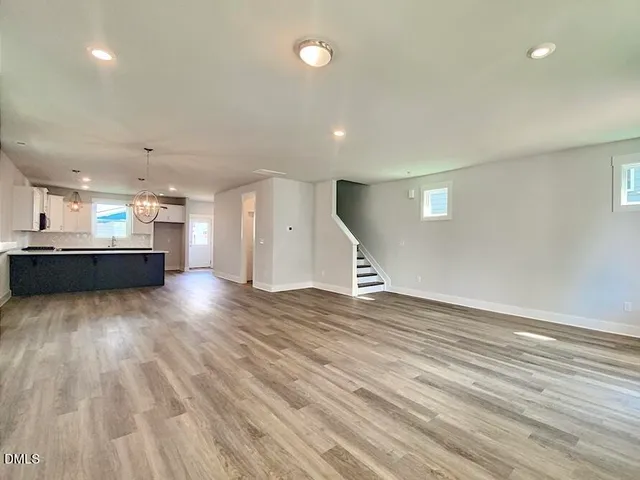 a view of kitchen and hall with wooden floor