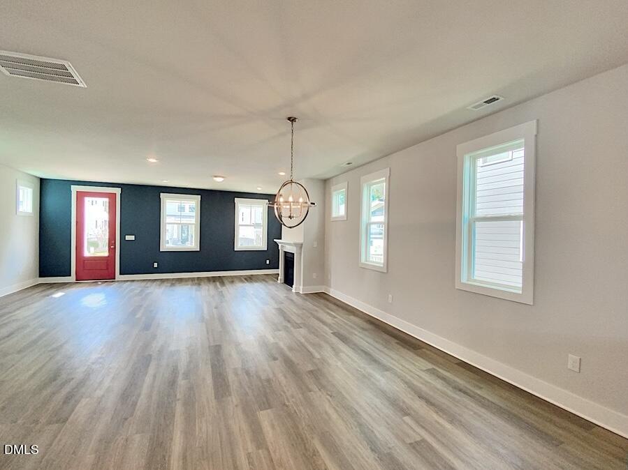 1309 Holding Village Way Wake Forest, NC 27587 - Photo 5 of 28 an empty room with wooden floor and windows