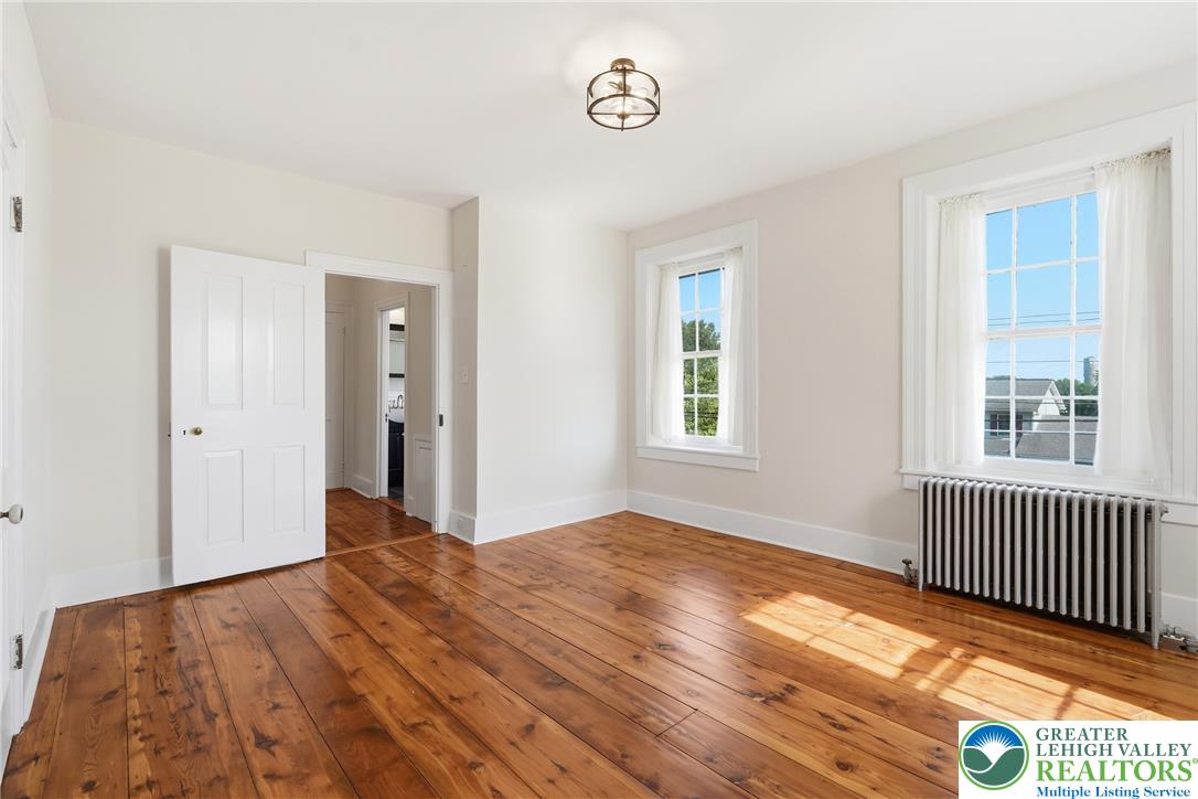 4682 Steuben Road Bethlehem, PA 18020 - Photo 28 of 79 Ample natural light illuminates warm wood flooring in this inviting living space.