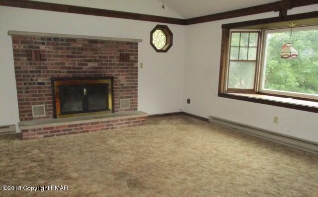 2817 Jackson Road Stroudsburg, PA 18360 - Photo 7 of 22 a view of an empty room with a fireplace and a window