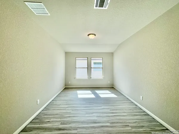 a view of a room with wooden floor and window
