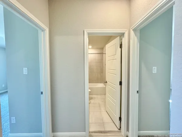 a bathroom with a glass shower door and a mirror
