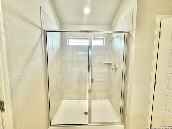 a bathroom with a glass shower door