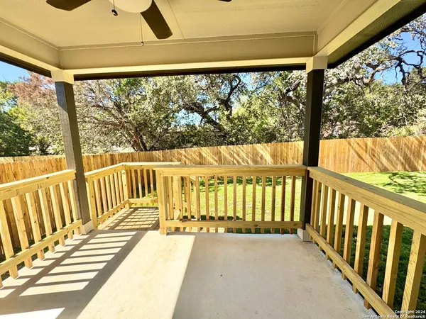 a view of a balcony with wooden floor