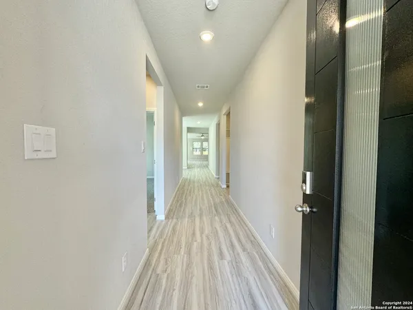 a view of a hallway with wooden floor