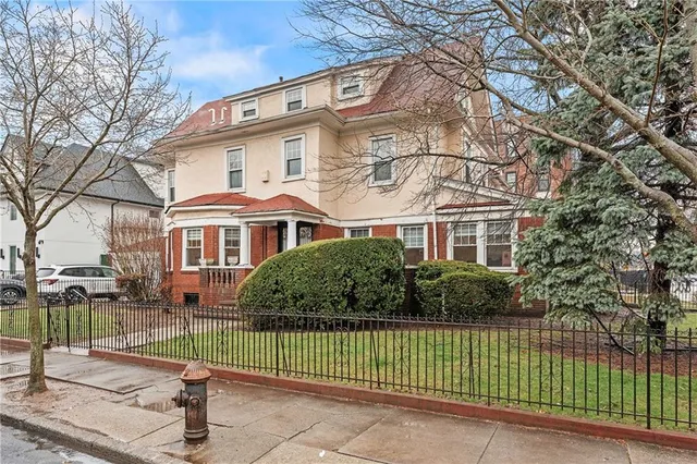 a front view of a house with a garden