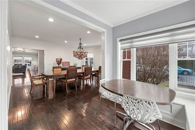 a dining room with furniture and wooden floor