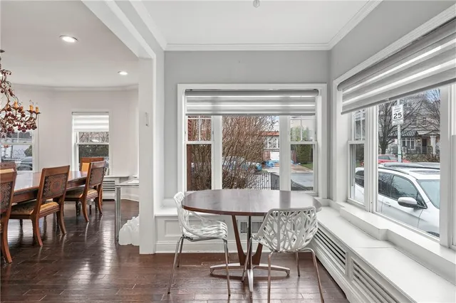 a living room with furniture and a large window with wooden floor