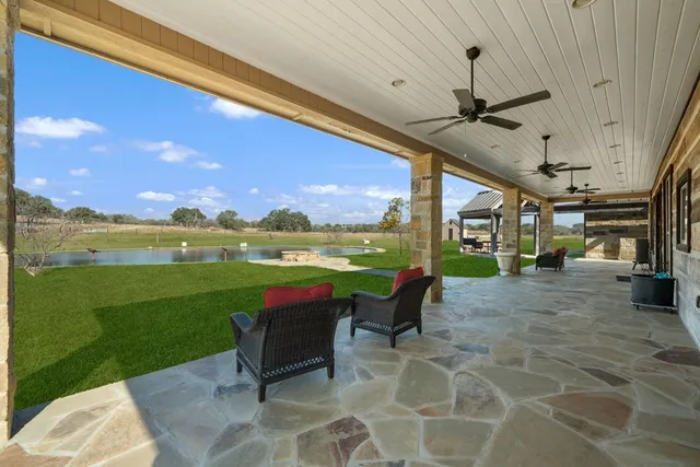 a view of a porch with furniture and garden