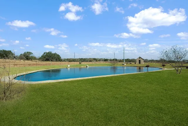 a view of a lake with houses in the background