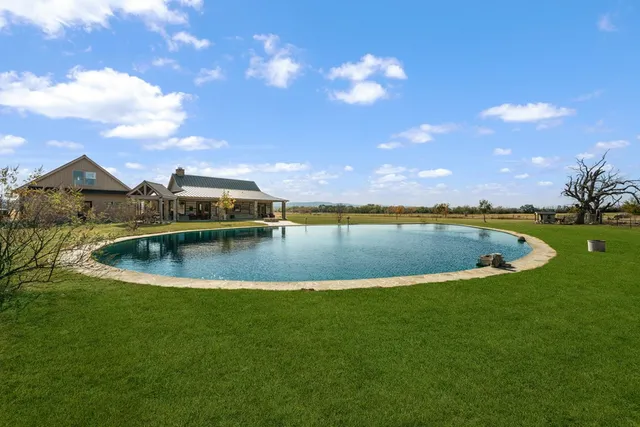 a view of a swimming pool and mountains in the background