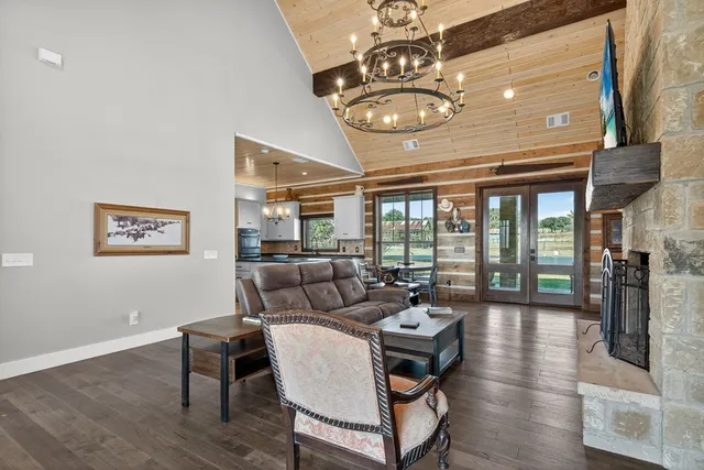 a living room with lots of furniture and kitchen view