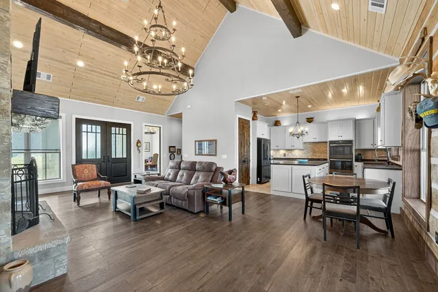 a kitchen with cabinets appliances and a chandelier