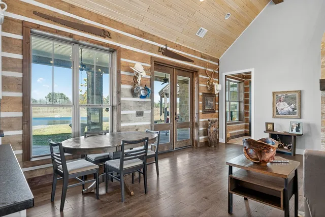 a living room with furniture wooden floor and a view of kitchen