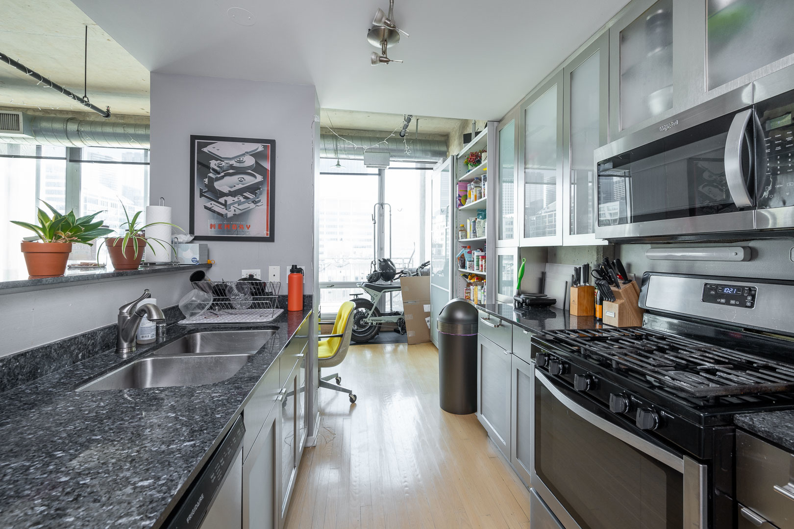 700 West Van Buren Street, Unit PH3 Chicago, IL 60607 - Photo 14 of 20 a kitchen with stainless steel appliances granite countertop a sink stove and cabinets