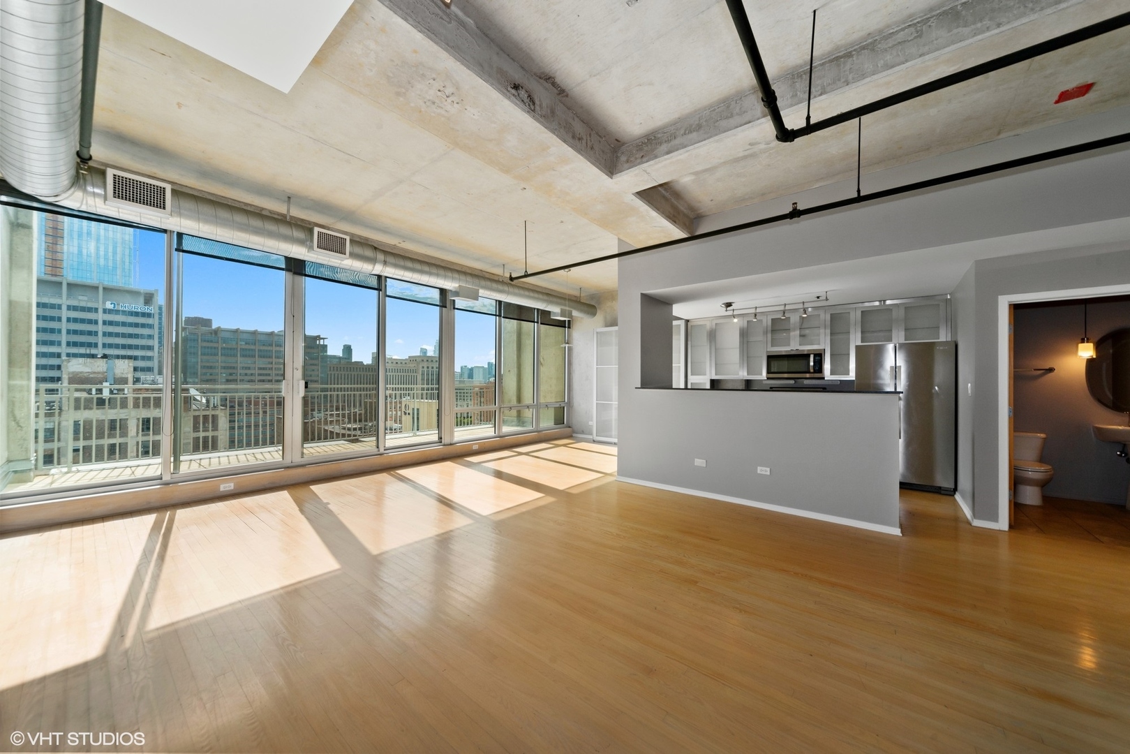 700 West Van Buren Street, Unit PH3 Chicago, IL 60607 - Photo 2 of 20 a view of empty room with wooden floor and fan