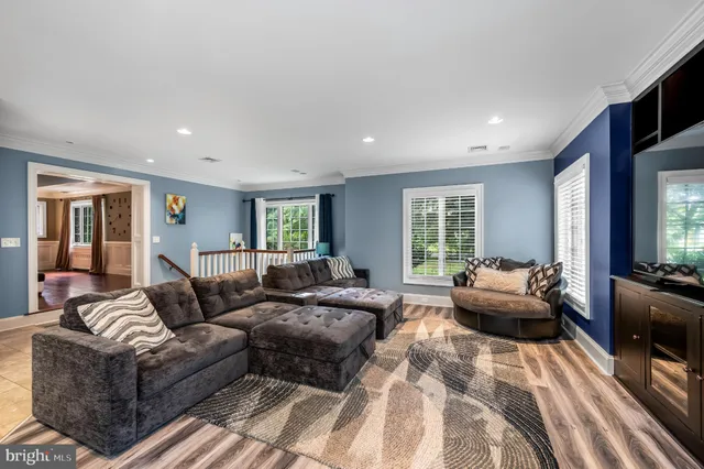 a living room with furniture and large windows