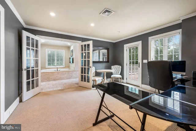 a view of a livingroom with workspace and a window