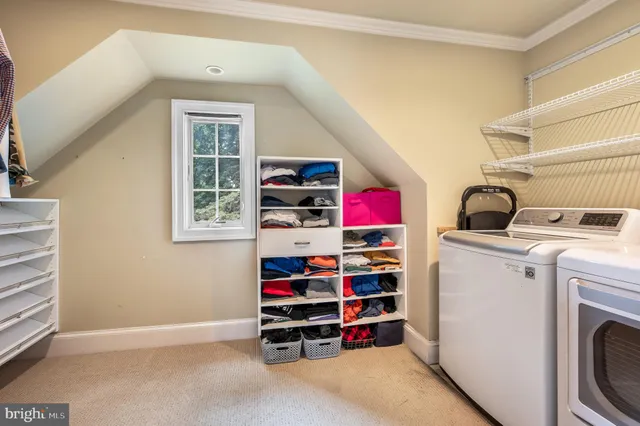 a view of storage and utility room with washer and dryer