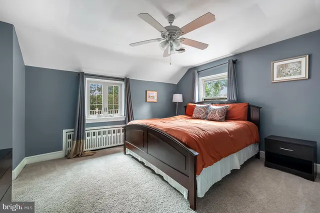 a spacious bedroom with a bed and a window