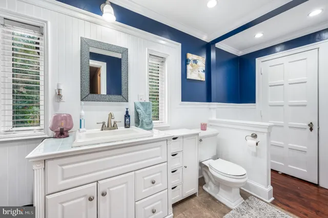 a bathroom with a sink a toilet and mirror