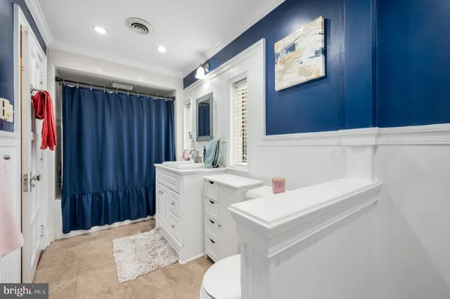 a bathroom with a sink toilet vanity and shower