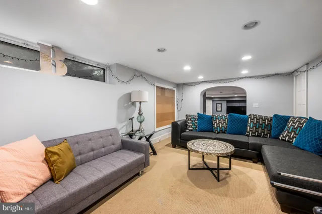 a living room with furniture and a glass door
