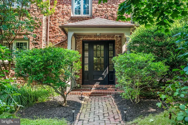 a front view of a house with plants