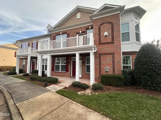 a front view of a house with garden and porch