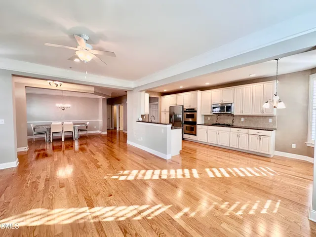a living room with furniture and kitchen view