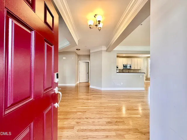 a view of an empty room with a fireplace and a window
