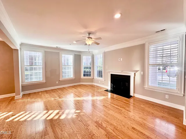 a large kitchen with kitchen island a large counter top stainless steel appliances and cabinets
