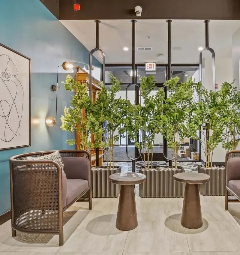 1211 North LaSalle Drive, Unit 401 Chicago, IL 60610 - Photo 9 of 15 a dining room with couches chairs and potted plants