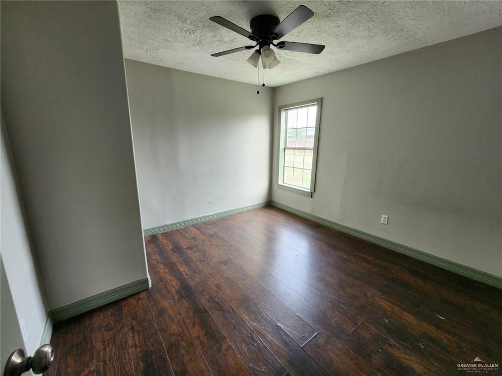 2002 Thornton Street Mission, TX 78572 - Photo 10 of 20 an empty room with wooden floor and windows