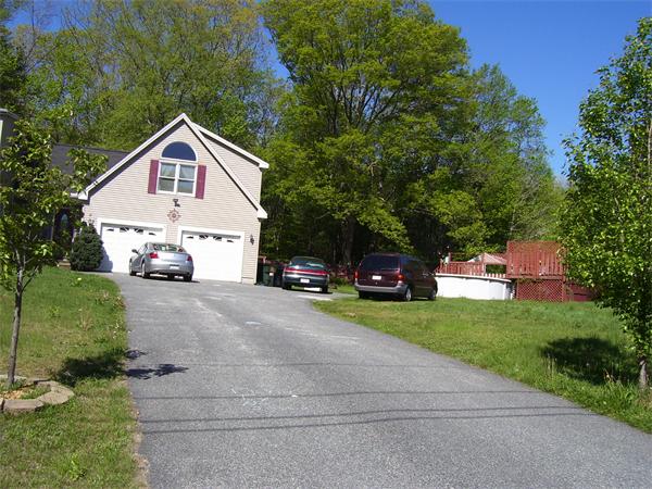 78 Blood Road Charlton, MA 01507 - Photo 5 of 25 a front view of a house with a yard and garage