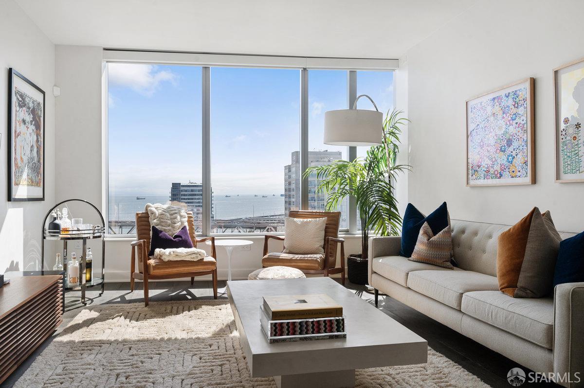a living room with furniture and a potted plant