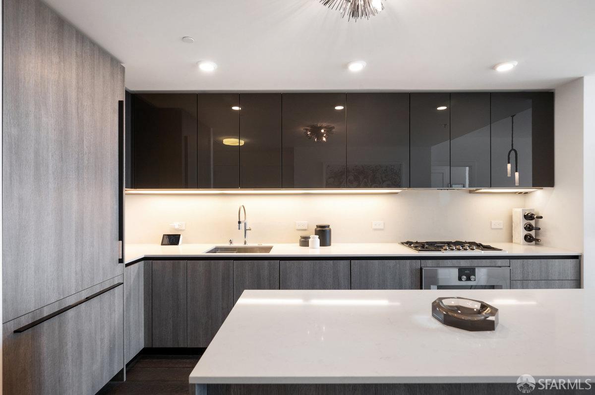 201 Folsom Street, Unit 22F San Francisco, CA 94105 - Photo 12 of 53 a kitchen with kitchen island granite countertop a sink and cabinets