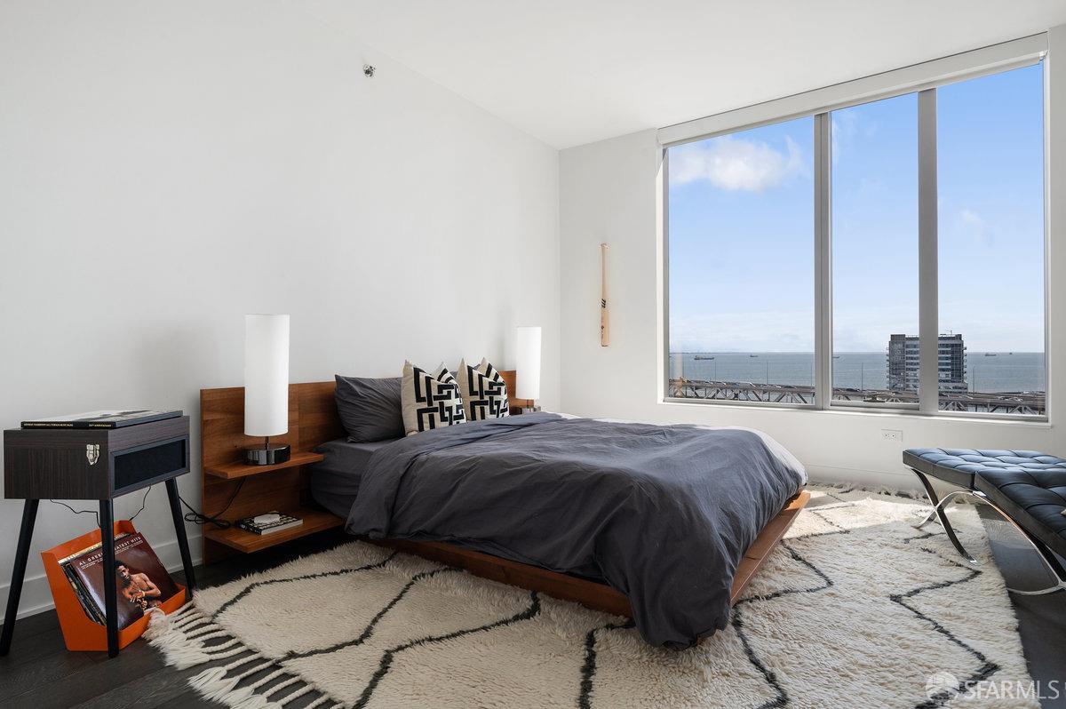 201 Folsom Street, Unit 22F San Francisco, CA 94105 - Photo 24 of 53 a bedroom with a bed and wooden floor