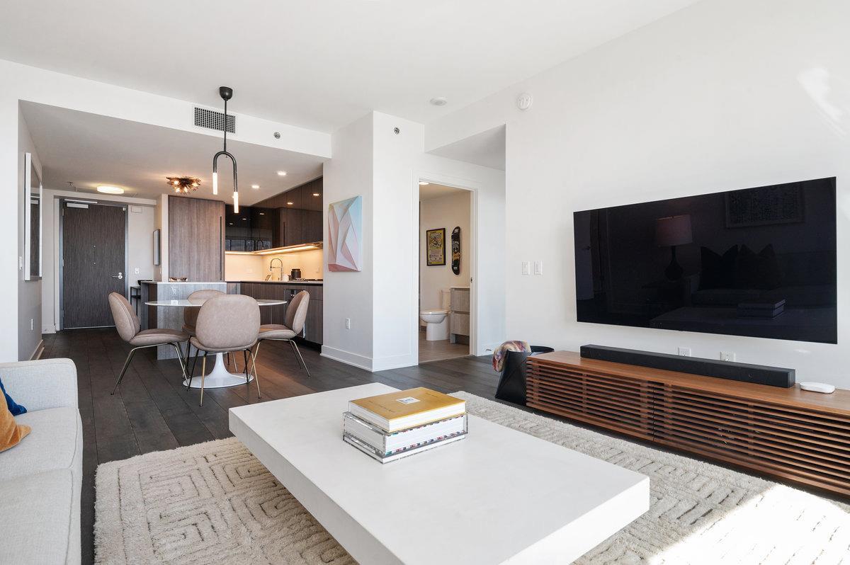 201 Folsom Street, Unit 22F San Francisco, CA 94105 - Photo 6 of 53 a living room with furniture and a flat screen tv