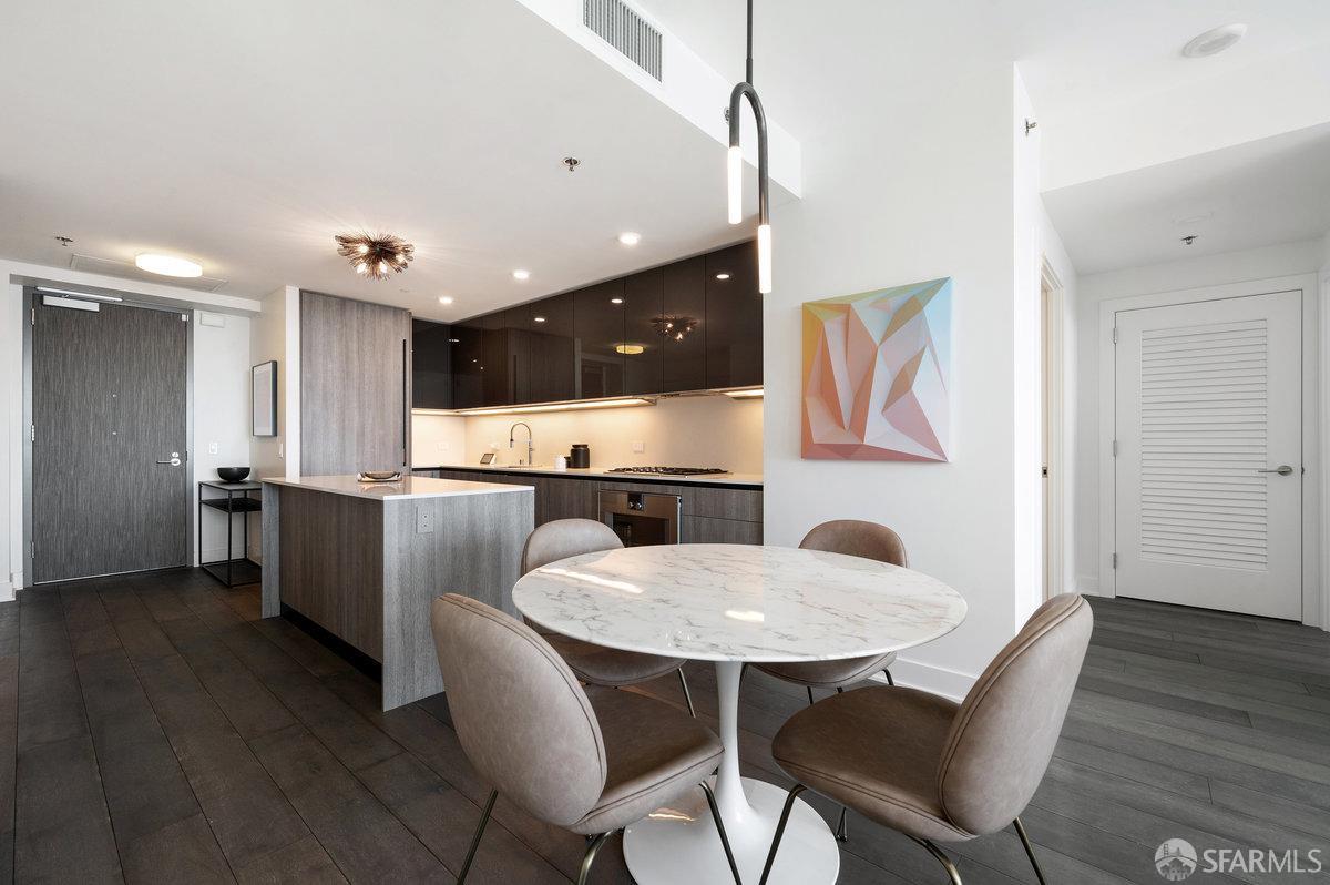 201 Folsom Street, Unit 22F San Francisco, CA 94105 - Photo 9 of 53 a kitchen with stainless steel appliances kitchen island granite countertop a kitchen island hardwood floor and a sink