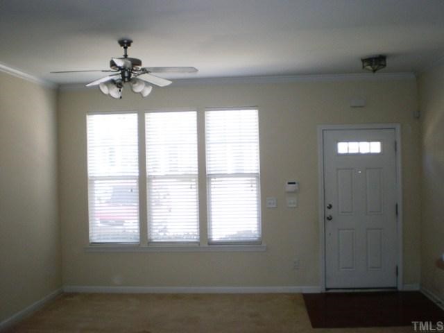 View of family room from the kitchen.  Large windows on front of home provide tons of natural light.