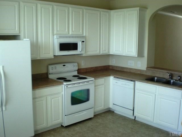 Spacious kitchen with solid surface counter tops.