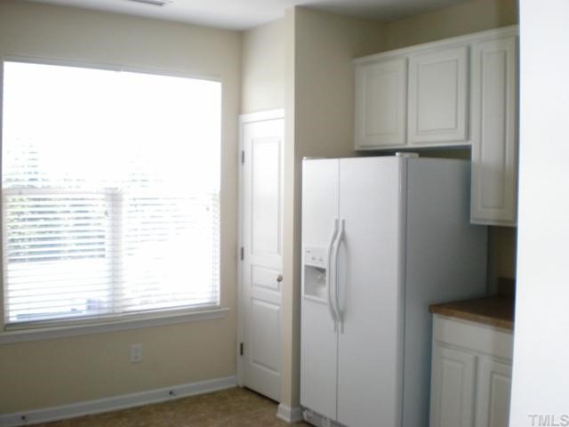 Large kitchen window overlooks patio and back yard.