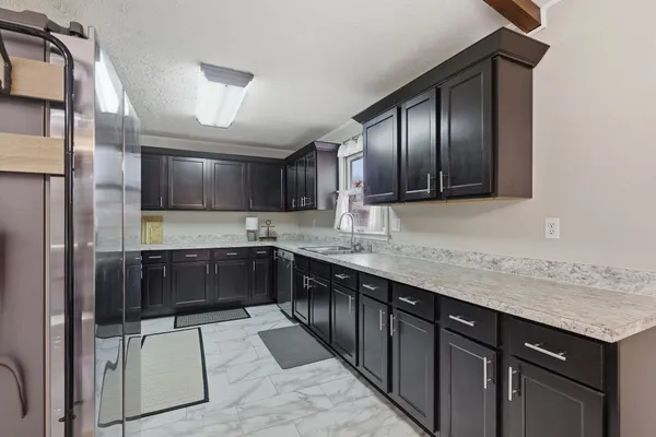 a kitchen with stainless steel appliances granite countertop a sink and cabinets