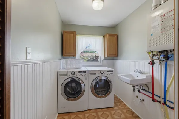 a utility room with sink dryer and washer