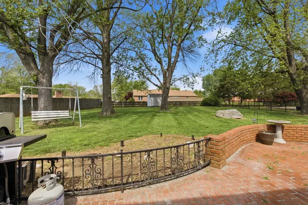 a front view of a house with a garden and trees