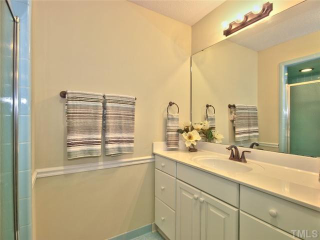 2701 Smokey Ridge Road Raleigh, NC 27613 - Photo 12 of 25 master bath has new light fixtures, a new vanity, tile flooring and shower. Master Bath/Spa