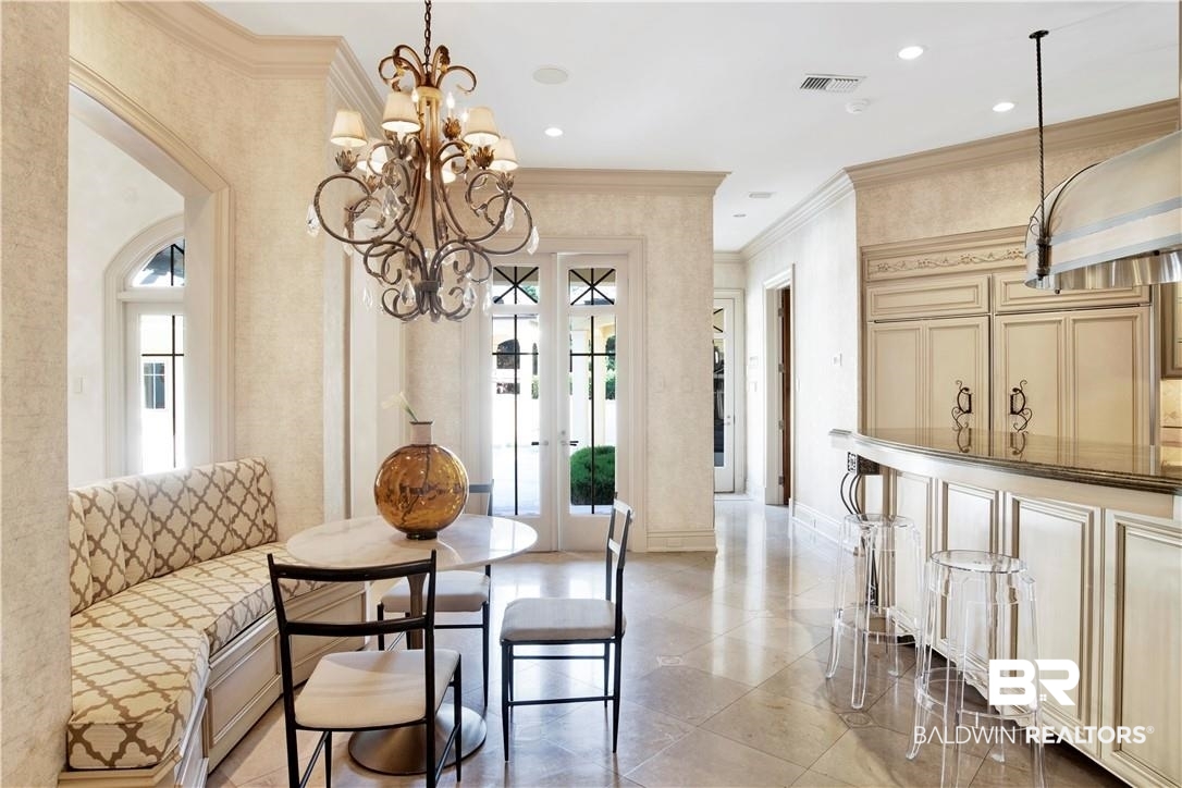 4 Chancery Court Mobile, AL 36608 - Photo 15 of 54 Dining area featuring ornamental molding and a notable chandelier
