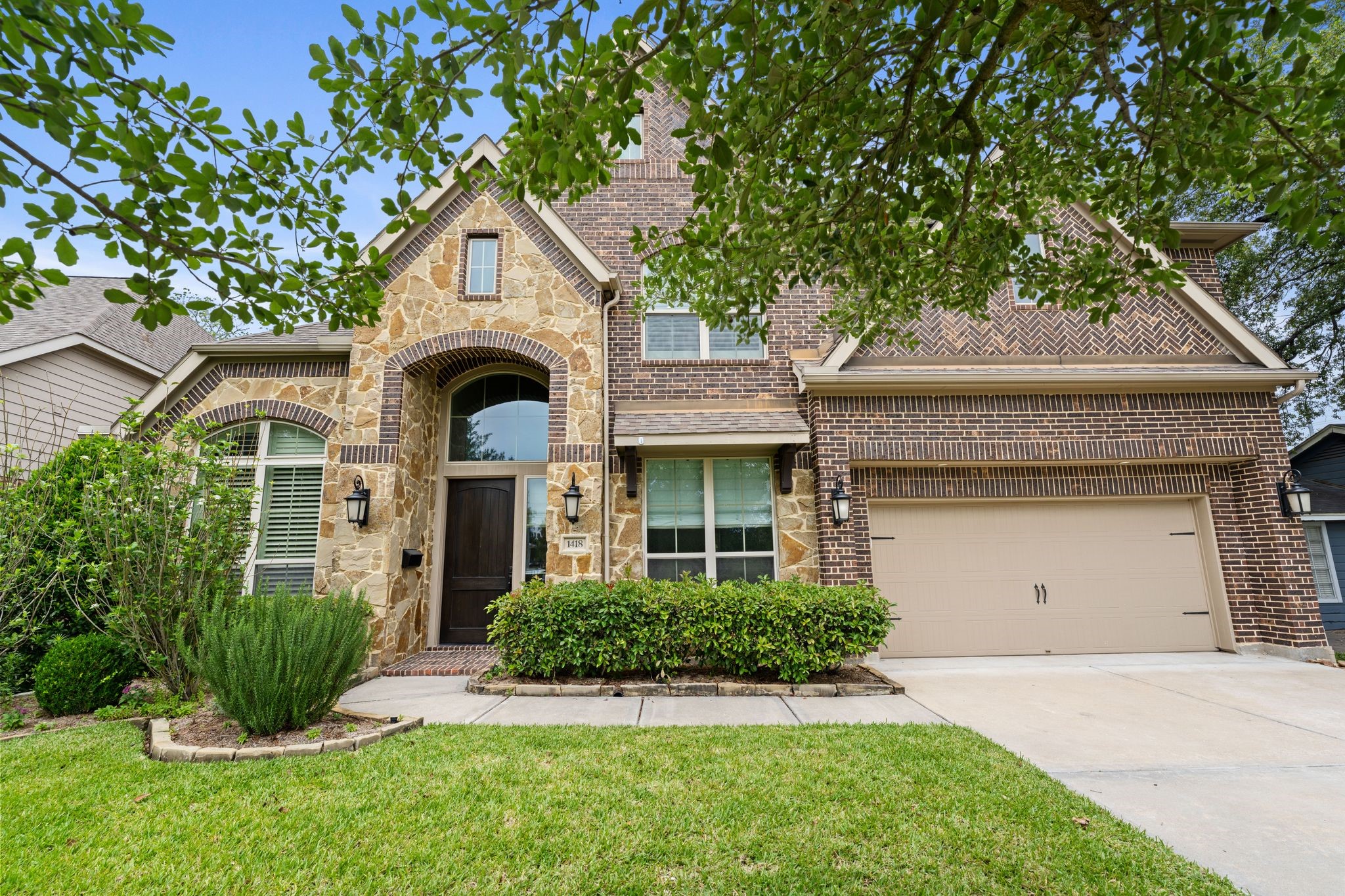 1418 Du Barry Lane Houston, TX 77018 - Photo 1 of 45 a front view of a house with a garden and plants