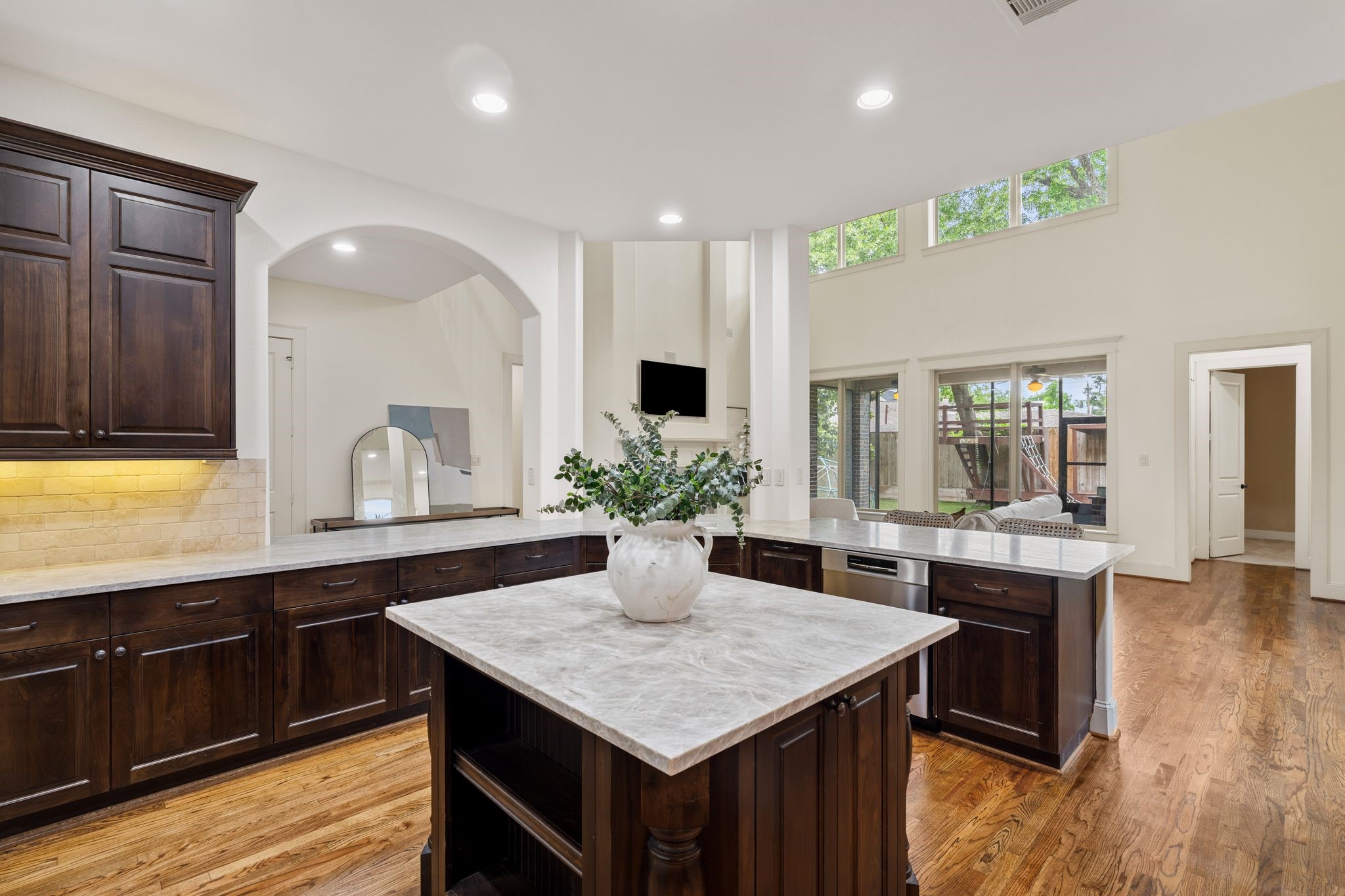 1418 Du Barry Lane Houston, TX 77018 - Photo 14 of 45 a kitchen with a kitchen island wooden floor center island and stainless steel appliances
